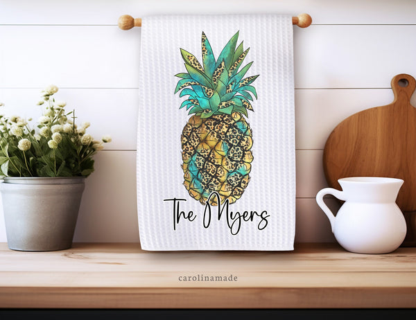 Teal and yellow leopard print pineapple on a waffle weave towel. Personalized with family name at the bottom.