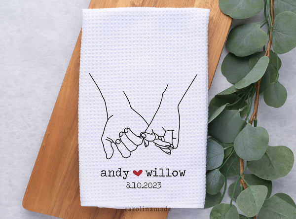 White waffle weave towel with holding hands design. Personalized with names and wedding date.
