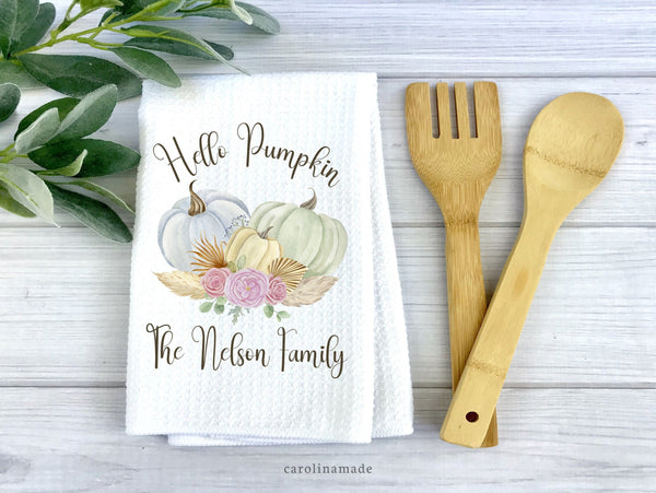 White waffle weave towel with hello pumpkin text and watercolor floral pumpkins. The family name is personalized under the design.