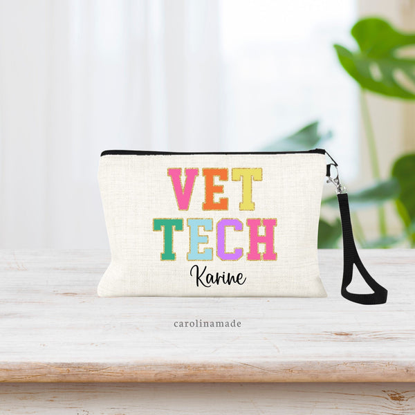 Linen wristlet makeup bag with trap that says VET TECH in varsity patch letters. Personalized with name under it.