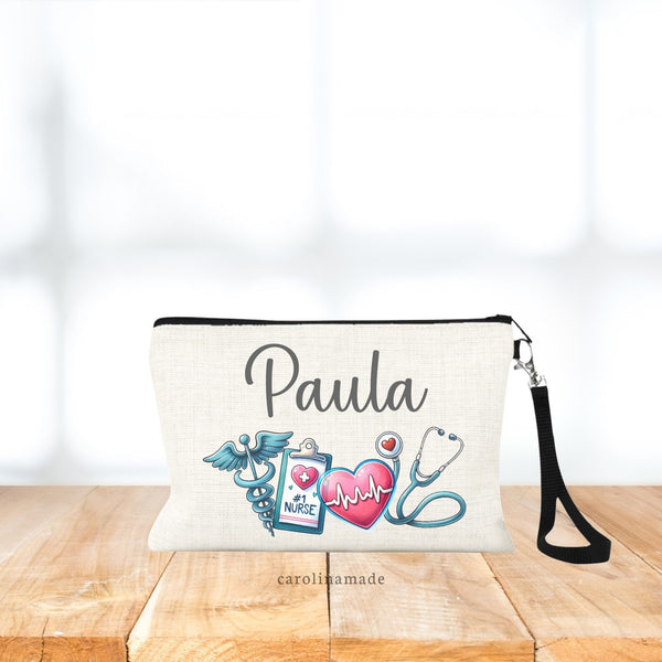 Linen wristlet bag with black strap. Personalized with medical items - symbol, clipboard that says #1 Nurse, Heart and stethoscope. The top says your name.