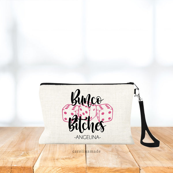 Wristlet bag features three dice in the center with the text bunco bitches and your name personalized at the bottom.