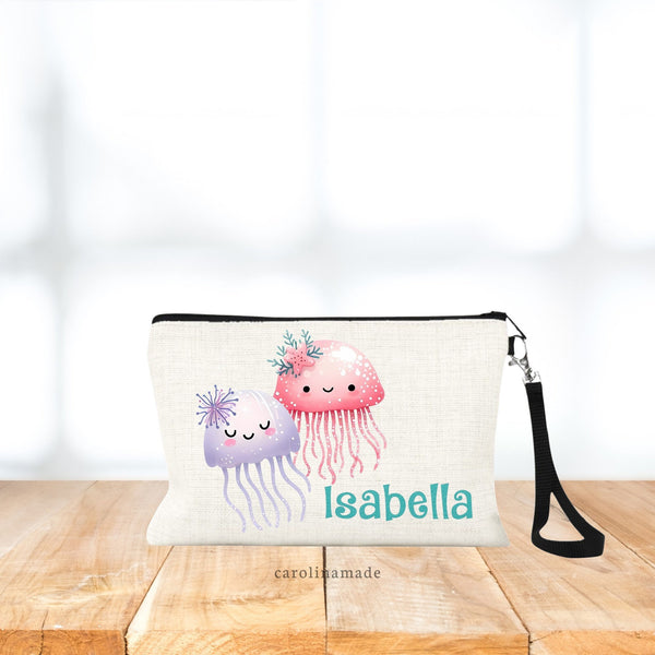 This zippered pouch features two jelly fish, one purple, one pink. And is personalized is with your name in teal glitter color.