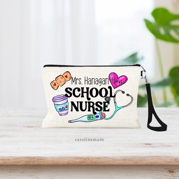 Linen wristlet that says School Nurse with the name on top of it. There is nursing clipart surrounding title. bandage, Heart, Thermometer, Stethoscope and nurse fuel coffee.