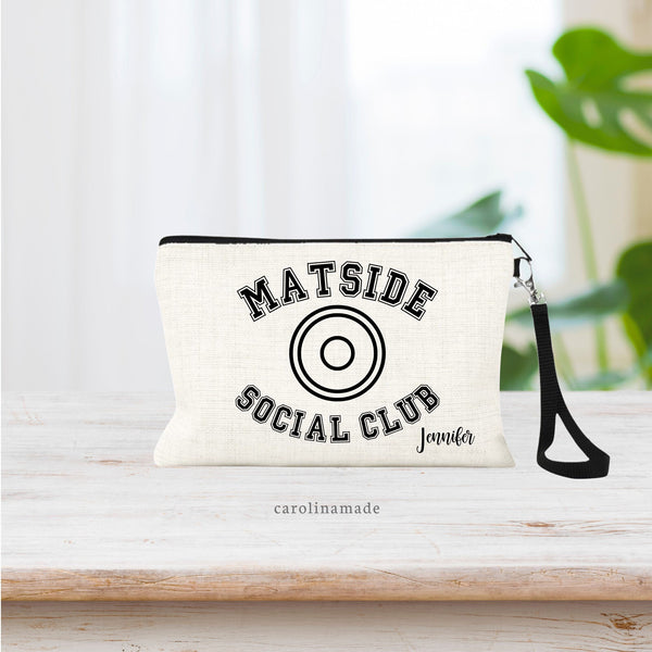 This linen wristlet bag with strap features the text Mat Side Social Club with a wrestling circle symbol in the center. Personalize for your wrestling mom friends with their name in the bottom corner.