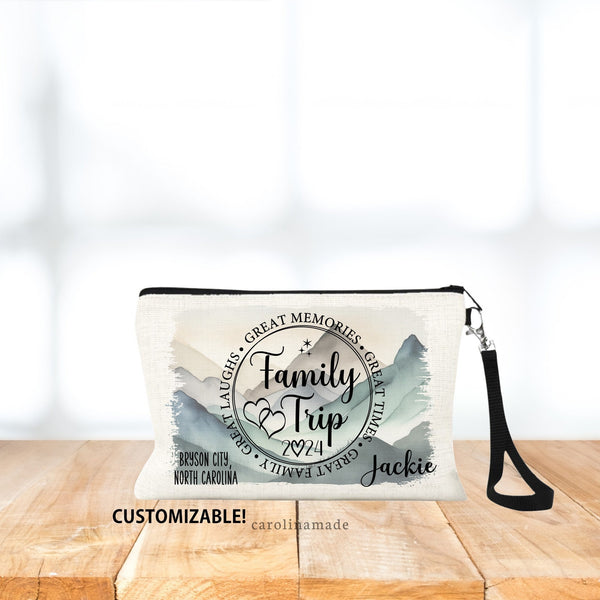This linen zipper pouch features a circle that says: Family Trip, with stars, and hearts. The year is noted at the bottom. Personalize with your name and destination. Background is customizable, mountains, beach, camping, or just a color.