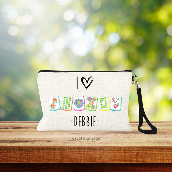 This linen wristlet is the perfect Mahjong bag! It features a bright color mah jongg tiles. Text says I Heart and then shows the tiles. Your name is personalized at the bottom.