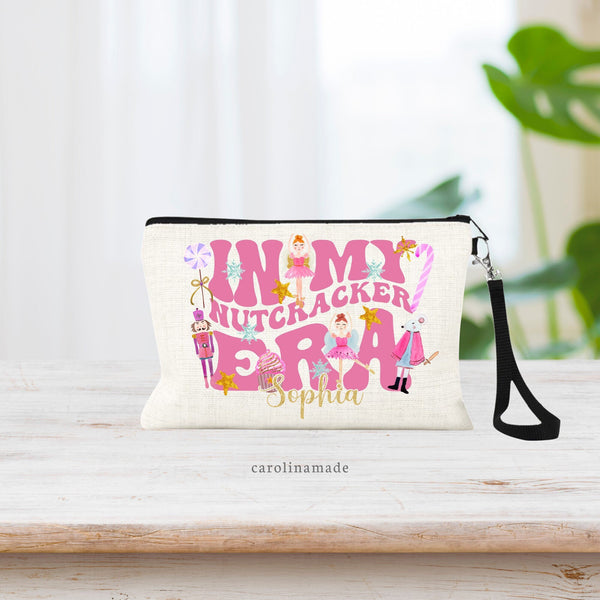 This linen zipper pouch features large text that says: In my Nutcracker era with various nutcracker characters and art around the text. The bottom is personalized with your name.