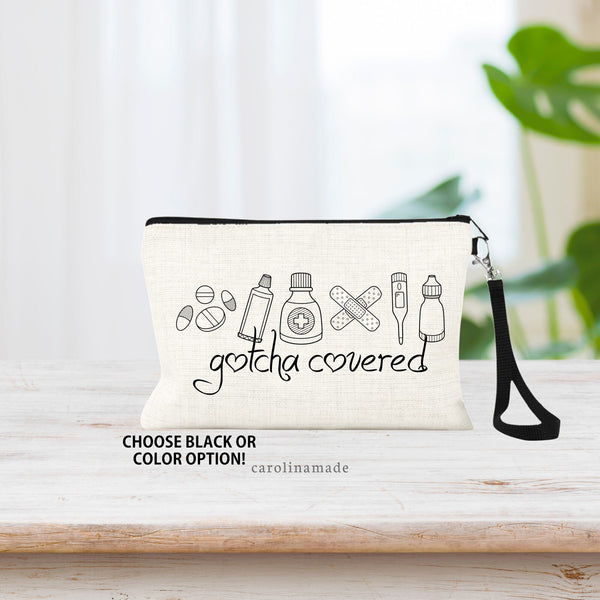 This linen wristlet is the perfect accessory to hold your first aid stuff. The design on the bag shows minimalist line art of medicine, ointment, band aids, thermometer and eye drops.  Under it says Gotcha Covered. Choose black or color option