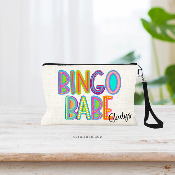 This zipper pouch says BINGO BABE in large letters on the bag in a colorful marquee style font. Your name is personalized on the bottom corner.
