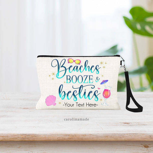 This linen zipper pouch features the text: Beaches Booze & Besties in a blue & teal printed glitter color with beach elements around the text. Sunglasses, sea shell, cocktail. Your text is personalized on the bottom of the bag.
