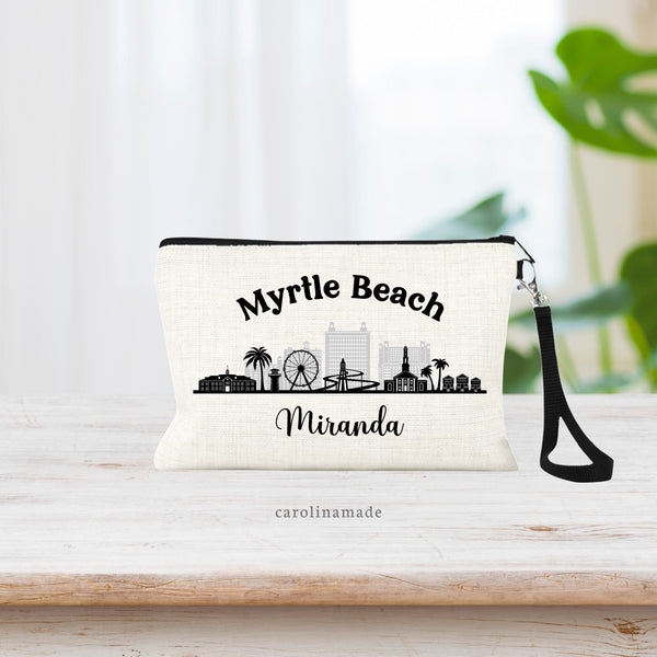 This linen wristlet features the Myrtle Beach Skyline with buildings, Ferris wheel, palm trees. Personalize the bottom with your name and customize the text at the top for your trip.
