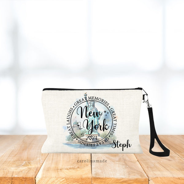 This linen zipper pouch features the Statue of Liberty in the background in a beautiful watercolor design. The text over top says New York 2024. Great Memories, Great Times, Great Friends, Great Laughs. Personalize with your name at the bottom.