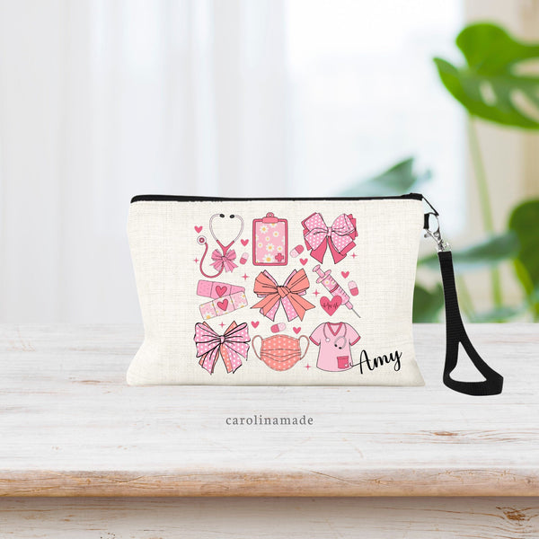 This beautiful linen wristlet pouch has a pink coquette bows and nursing items design featuring  pattern of bows, stethoscope, bandage, mask needle, and clipboard. The bottom corner is personalized with your favorite nurses name.