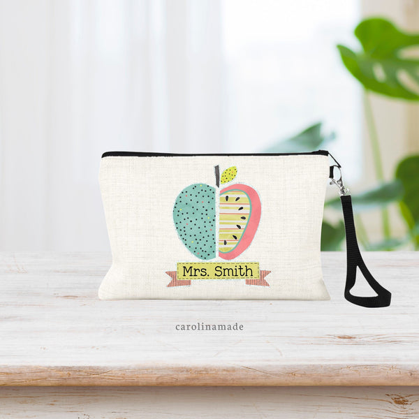 This natural linen zipper pouch features a beautiful colorful apple in the center with a banner under it to personalize with teachers name.