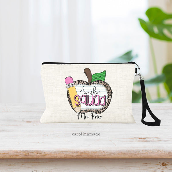 Personalized Sub Squad zipper pouch features a large leopard print & school paper designed apple with pencil in front. Text says Sub Squad on top the apple and is personalized at the bottom with your substitute teachers name.