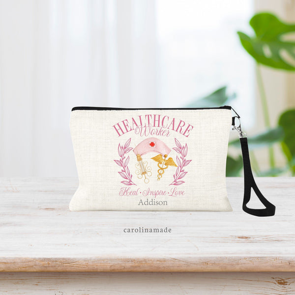 This pink girly Healthcare Worker zipper pouch Bag is perfect for the medical professional in your life. It features a pink nursing cap, vintage needle and gold medical symbol. Bottom says Heal Inspire Love and is personalized with your name.