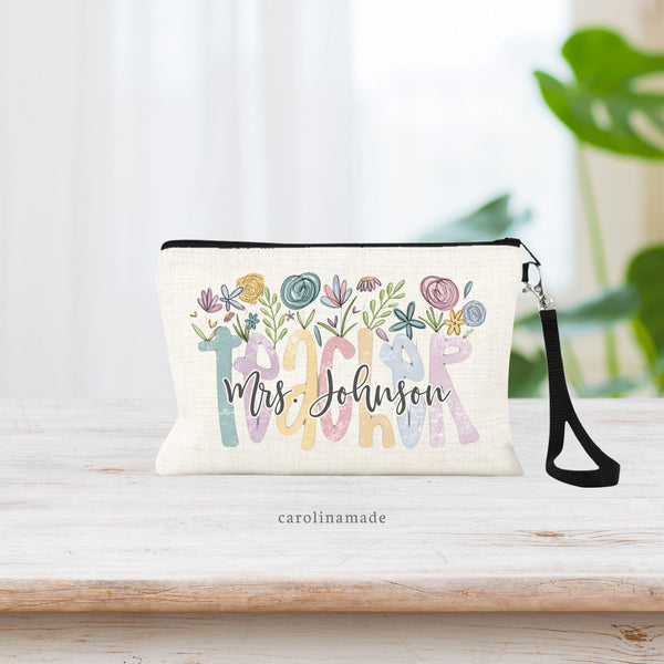 This beautiful teacher bag features the word teacher in the center in a fun colorful font. Their name is personalized over top of it the word teacher. Then at the top is fun colorful flowers and greenery.