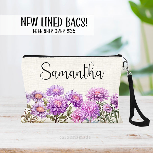 This zipper pouch features the purple September birth flower aster flowers across the bottom and is personalized with your name at the top.