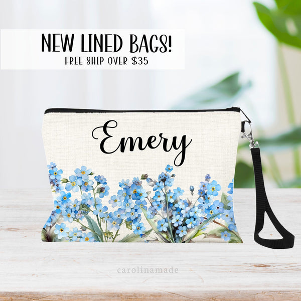 This zipper pouch features blue forget me not flowers along the bottom border and is personalized at the top with your name.