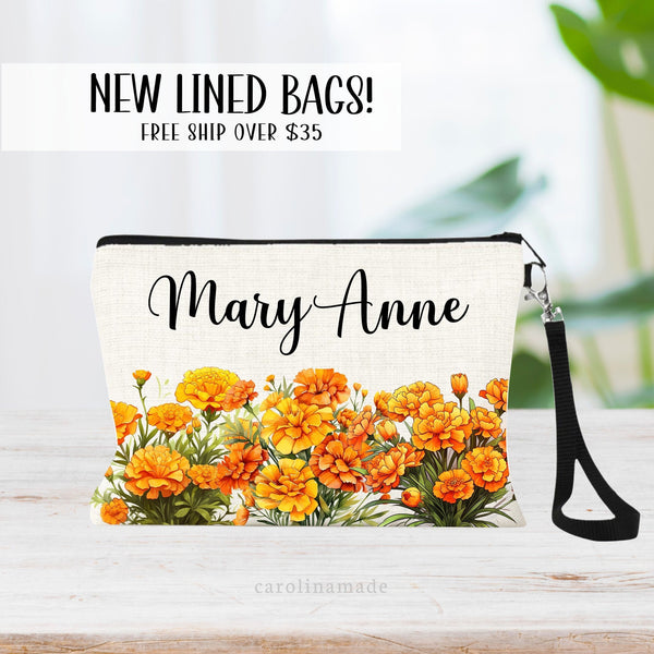 This zipper pouch features orange marigold flowers along the bottom border and is personalized at the top with your name. Perfect gift for October Birthdays!