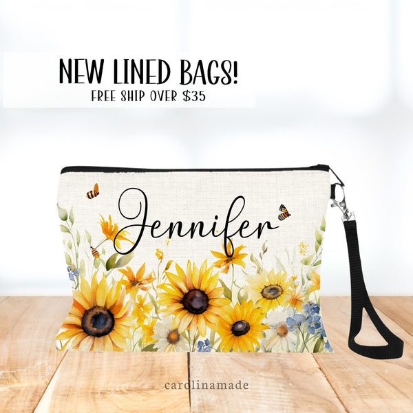 This zipper pouch features Sunflower & wildflowers along the bottom border and is personalized at the top with your name.