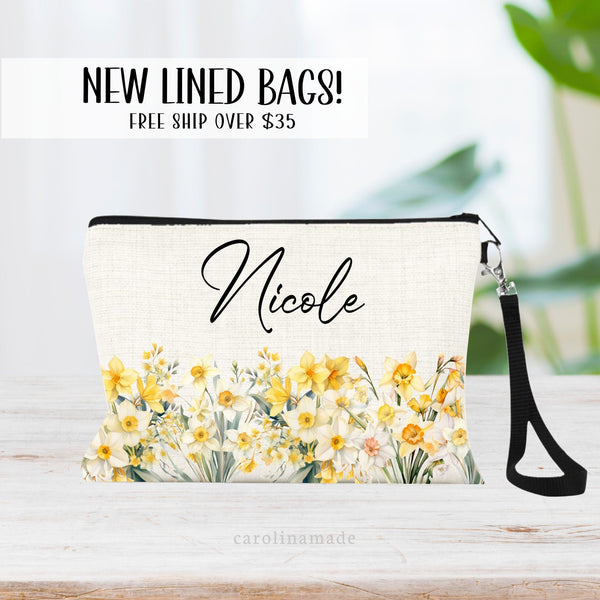 This zipper pouch features white and yellow narcissus flowers along the bottom border and is personalized at the top with your name. Perfect gift for December Birthdays!