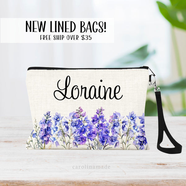 This zipper pouch features purple larkspur flowers along the bottom border and is personalized at the top with your name. Perfect gift for July Birthdays!