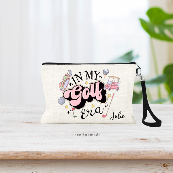 In my Golf Era zipper pouch bag! Fun girly colors with golf bag, golf cart, golf club, golf tee and ball. It is personalized in the bottom corner with your name.