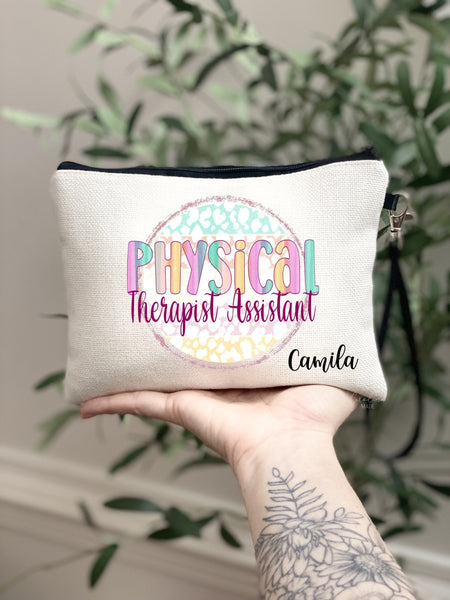 This linen zipper pouch features a fun colorful rainbow design with the text Physical Therapist Assistant in the center. The bag is personalized with your name in the bottom corner.