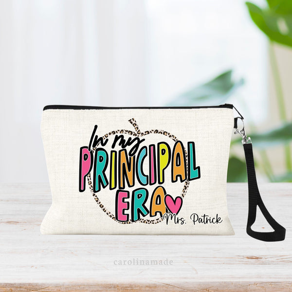 This linen zipper pouch features the text In my principal era in a bright colorful text with a leopard print apple outline in the back. Personalize the corner with a name.