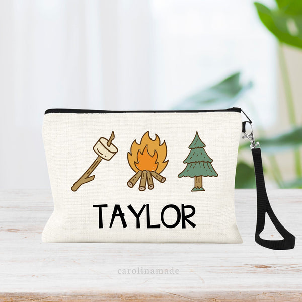 The design on this linen pouch shows a stick with marshmallow, camp fire and tree. It is personalized at the bottom with campers name.