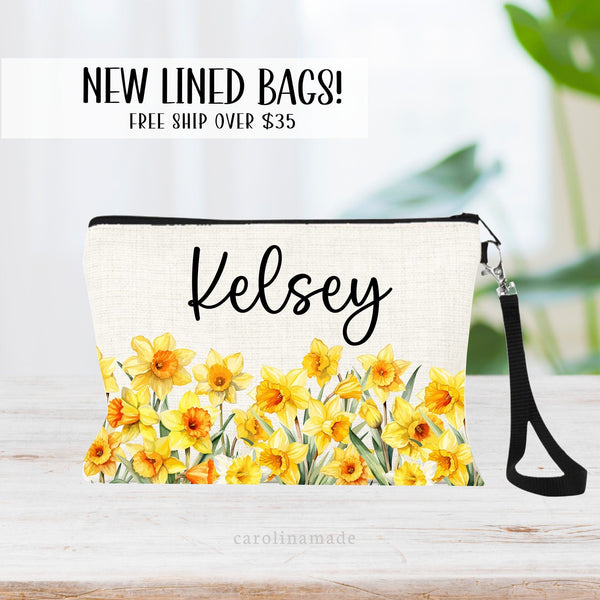 This zipper pouch features yellow daffodils flowers along the bottom border and is personalized at the top with your name. Perfect gift for February Birthdays!