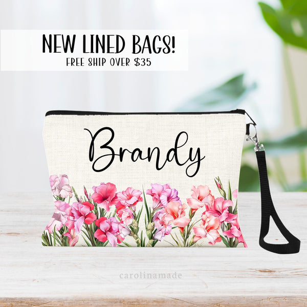 This zipper pouch features pink gladiolus flowers along the bottom border and is personalized at the top with your name. Perfect gift for August Birthdays!