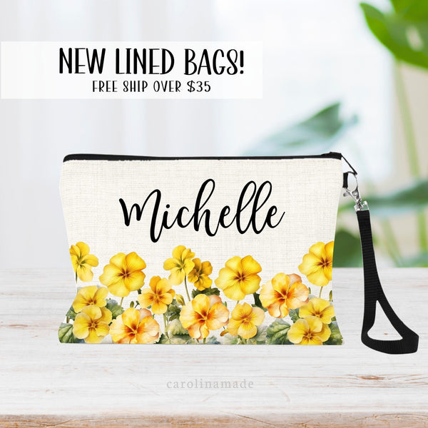 This zipper pouch features yellow primrose flowers along the bottom border and is personalized at the top with your name. Perfect gift for February Birthdays!