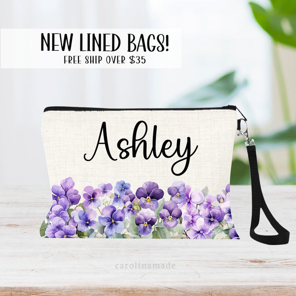 This zipper pouch features purple violet flowers along the bottom border and is personalized at the top with your name. Perfect gift for February Birthdays or Violet Weddings!