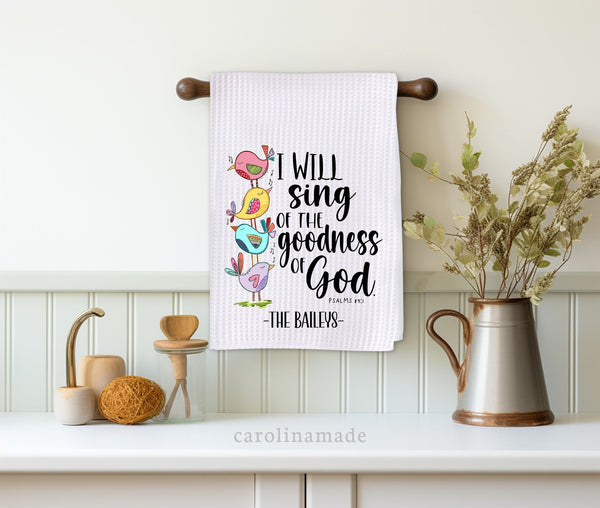 This white waffle weave towel shows colorful stacking birds singing the verse, Psalms 89 1 - I will sing of the goodness of God. It can be personalized at the bottom with your family name.