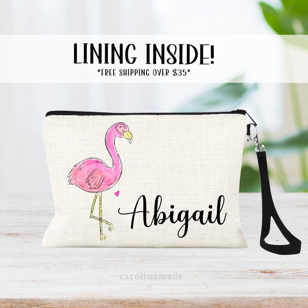 Pink Flamingo with your name personalized next to it on a beautiful lined linen zipper pouch wristlet bag.