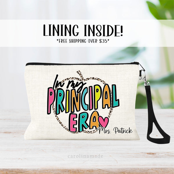 This linen zipper pouch features the text In my principal era in a bright colorful text with a leopard print apple outline in the back. Personalize the corner with a name.