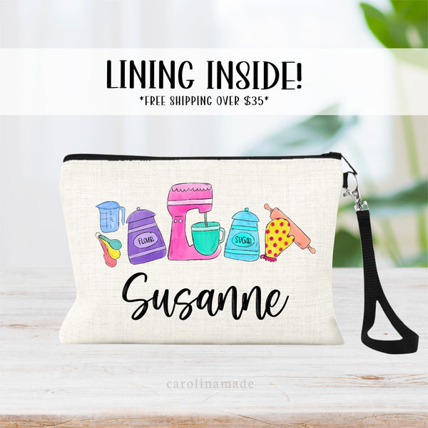 This linen zipper pouch features fun colorful baking items -flour, mixer, sugar, oven mitt, rolling pin, measuring spoons and cup. It is personalized at the bottom with a name.
