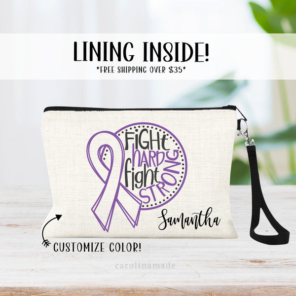 This linen wristlet features a large cancer ribbon in your choice of color with the text fight hard fight strong. It is personalized in the bottom corner with your name.