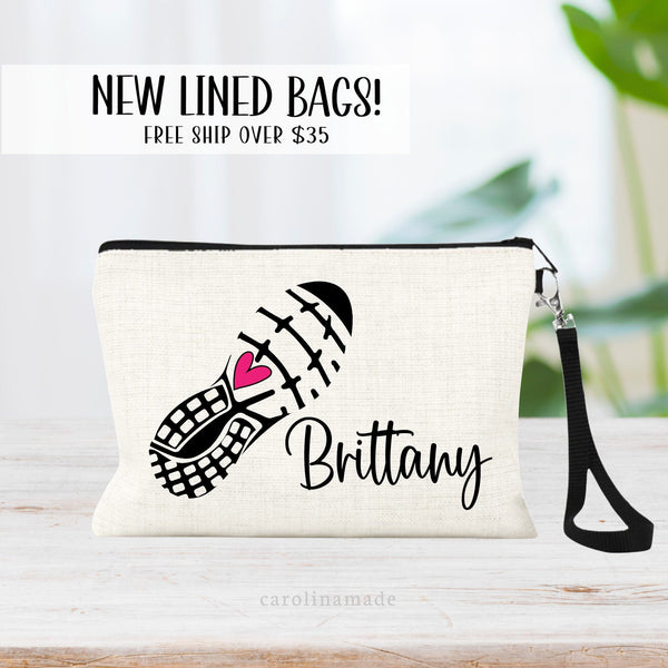 This linen zipper pouch features a large running sneaker with a pink heart in the center. It is personalized with your name next to the shoe.
