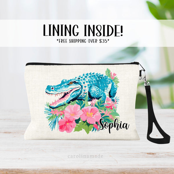 This linen zipper pouch features a pretty tropical floral and greenery design with a alligator. It is personalized in the corner with your name.
