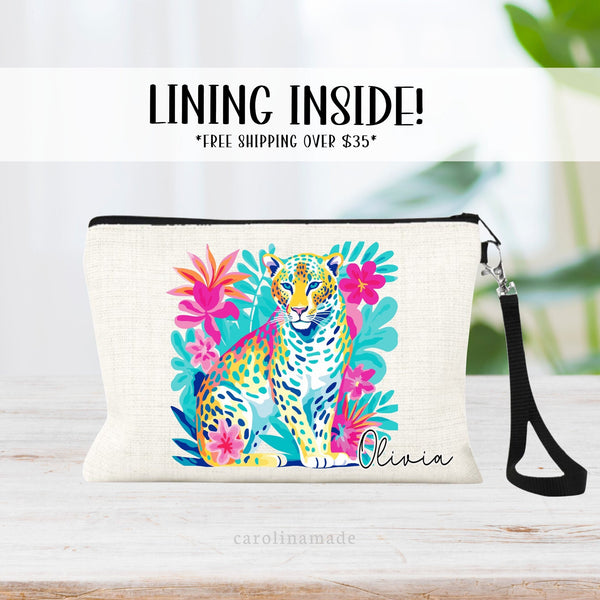 This linen zipper pouch features a pretty tropical floral and greenery design with a cheetah. It is personalized in the corner with your name.