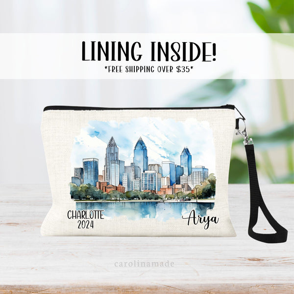 Beautiful watercolor design of downtown Charlotte North Carolina  in the middle of this linen wristlet bag. It is personalized with your name on bottom right, with Charlotte and the year on the bottom left.