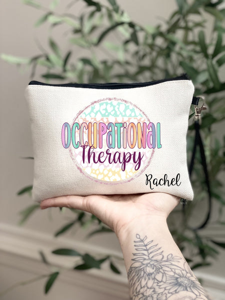This linen zipper pouch features a colorful rainbow design with Occupational therapy in the center. And is personalized with your name in the bottom corner.