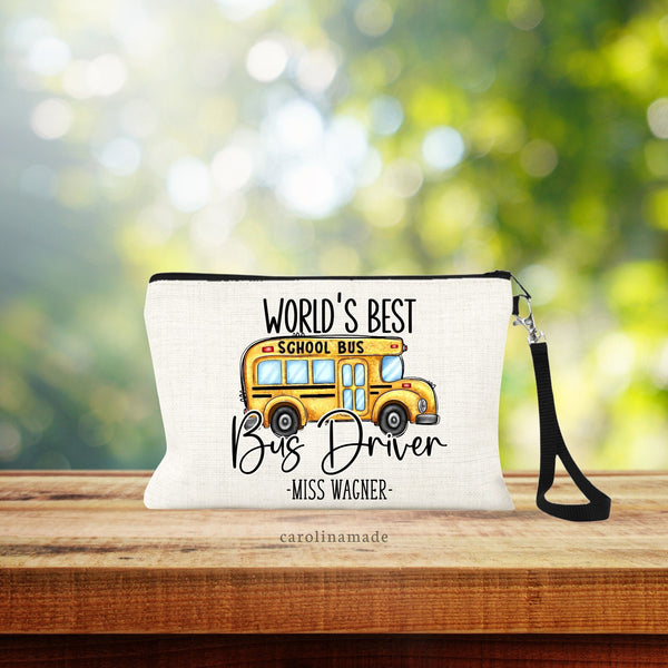 World Best Bus Driver personalized linen wristlet bag with clipart of school bus. Name is at the bottom.
