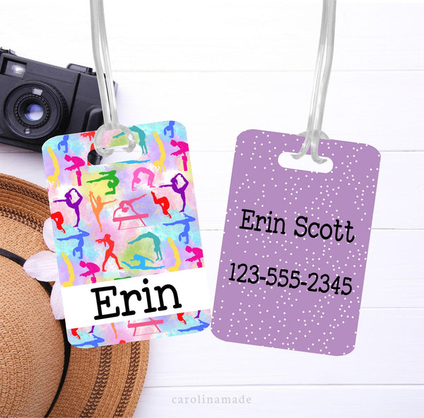 This aluminum tag features a colorful gymnastics design on the front with your name. The back is purple with white pokadots and is personalized with your name and contact information.
