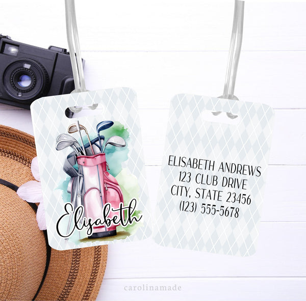 This aluminum tag features a gray argyle background with a watercolor pink golf bag and clubs. It has your name on the front and is personalized with your contact info on the back.