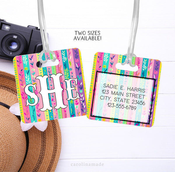This aluminum luggage tag features a colorful floral design on both sides. The front has a monogram. And the back is personalized with contact info.
